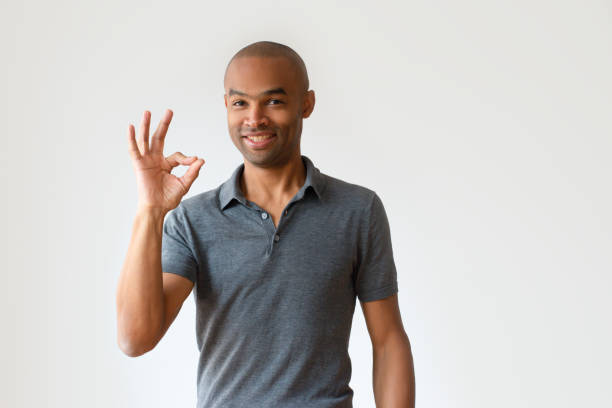 istock Smiling bald African American man showing ok sign 1075439582