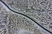 aerial view awesome view down to country road through winter snow forest trees