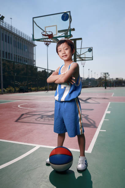 istock Cute little boy playing basketball 1075443344