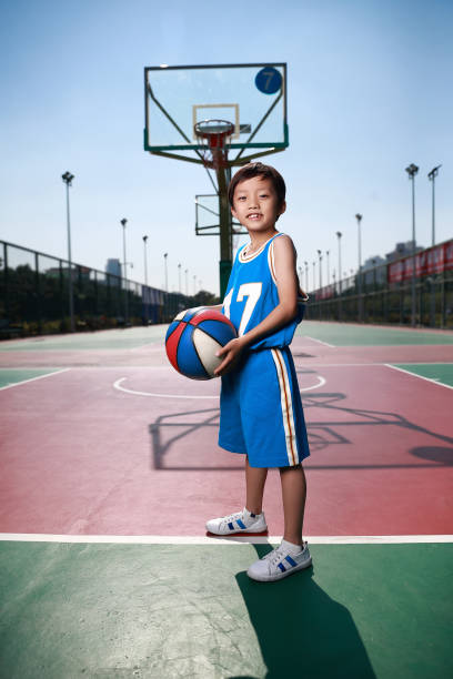 istock Cute little boy playing basketball 1075446172
