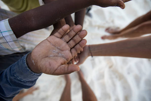 istock Pleading Hands of African Children 1075448346