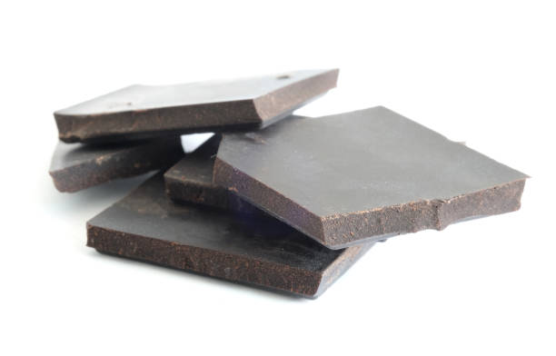 istock Chocolates are cut into pieces on a white background. Snack ideas 1075449692