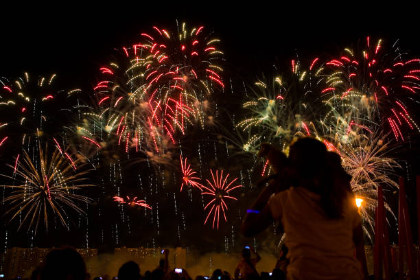 istock Viewers watch beautiful fireworks in the sky. 1075450798