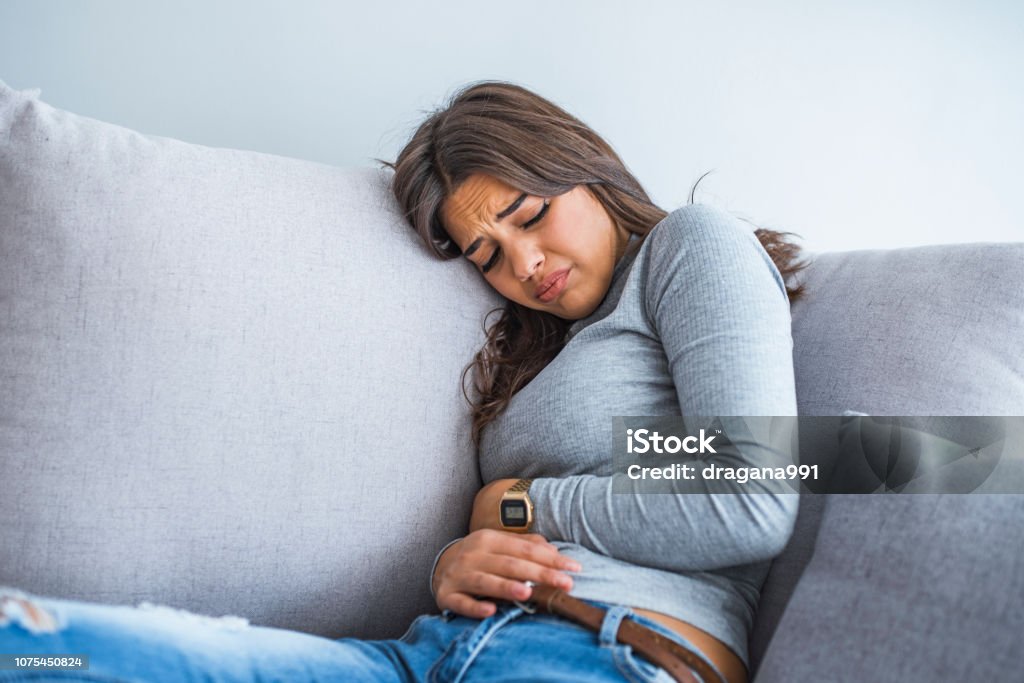 Young Sick Woman With Hands Holding Pressing Her Crotch Lower Abdomen Stock  Photo - Download Image Now - iStock