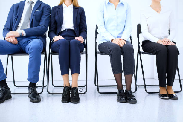 istock Group of business people sitting in office and waiting for job interview while using gadgets, close-up. Conference or training concepts 1075452000