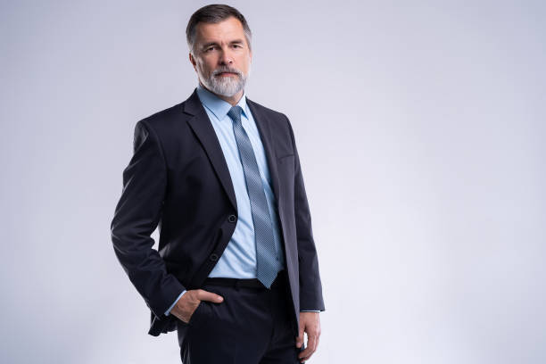 istock Happy satisfied mature businessman looking at camera isolated on white background. 1075455128