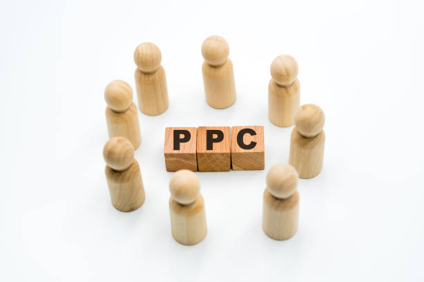 istock Wooden figures as business team in circle around acronym PPC Pay Per Click 1075456278