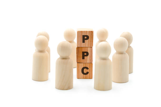 istock Wooden figures as business team in circle around acronym PPC Pay Per Click 1075456424