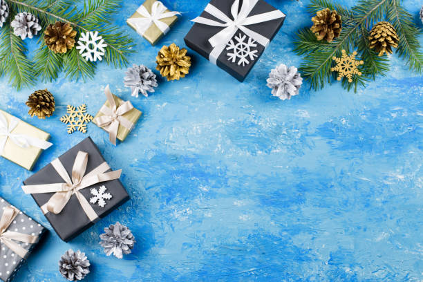 istock Blue Christmas frame with fir branches, black giftboxes, silver and golden decorations 1075460036