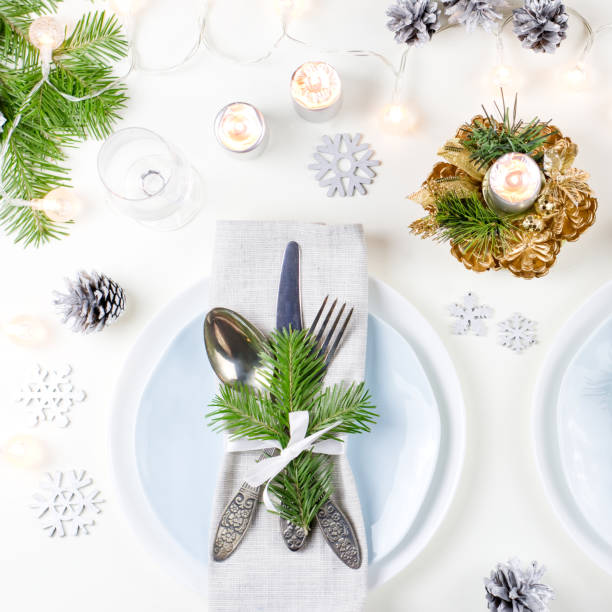 istock Christmas table setting with plates, silverware, presents, candles and decorations 1075461230