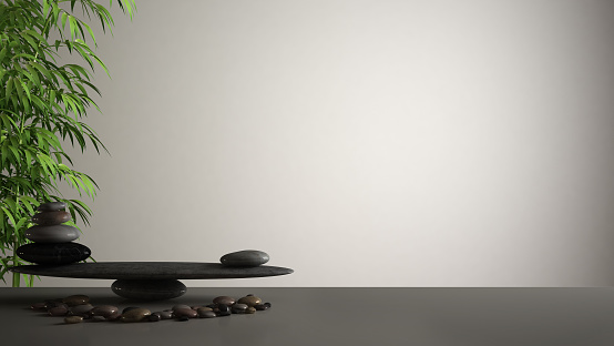 Empty interior design feng shui concept zen idea, white table or shelf with pebble balance and green bamboo, over white blank background copy space