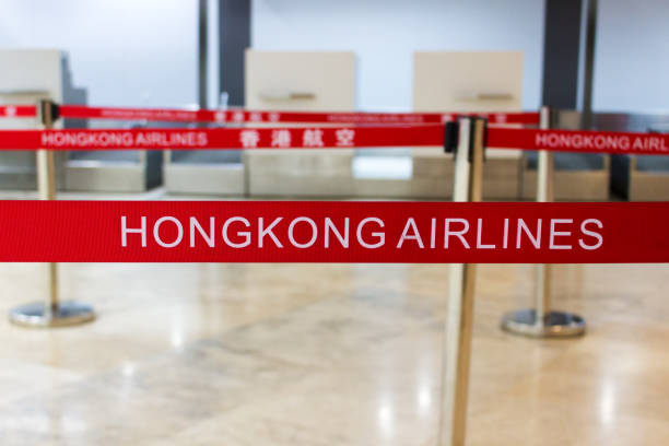 red tape with hongkong airlines inscription - airport airport check in counter arrival departure board checkout counter imagens e fotografias de stock