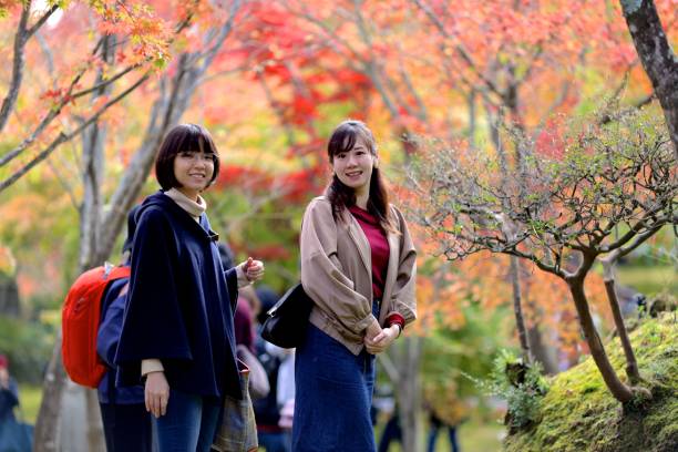 istock Young women enjoying autumn foliage 1075481658