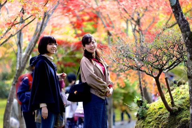 istock Young women enjoying autumn foliage 1075481800