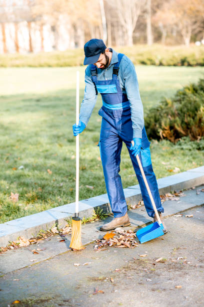 istock Cleaner sweeping leaves outdoors 1075497758