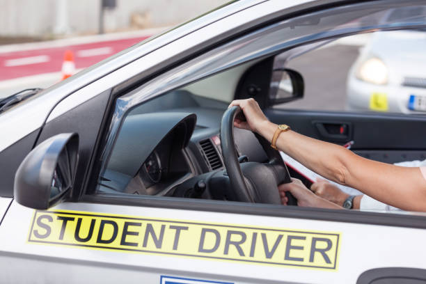 istock Middle-aged woman learning to drive a car 1075498250