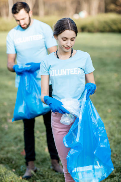 istock Volunteers portrait with rubbish bags in the park 1075498564