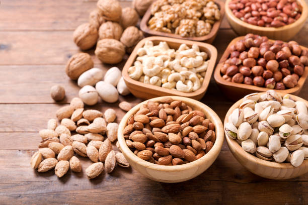 istock bowls of nuts on wooden table 1075504676