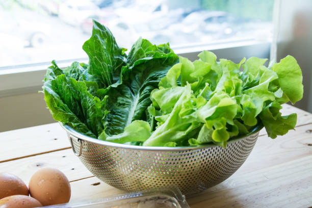 istock Green leafy vegetables with eggs on wooden background 1075505782