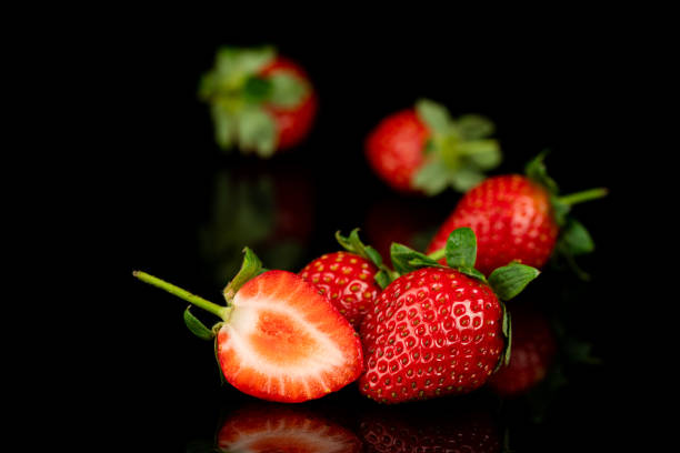 istock red strawberry on bla background 1075513282
