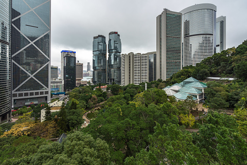 Aerial view of Hong Kong Park: on the left Bank of China building, in the middle the twin-tower complex Lippo Center, on the right the Forsgate Conservatory. Hong Kong, January 2018