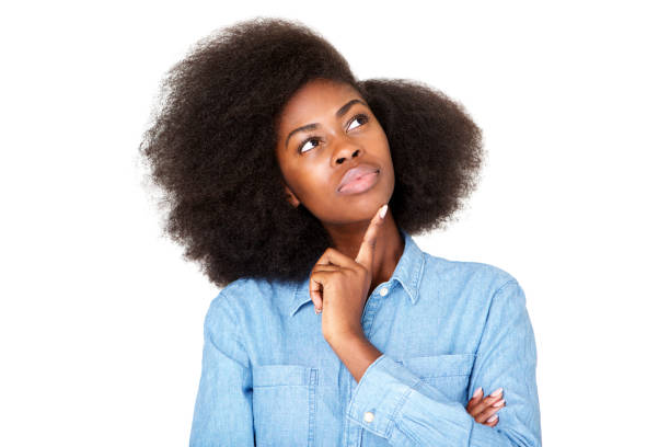 istock Close up thinking young black woman with afro looking up at copy space 1075520888