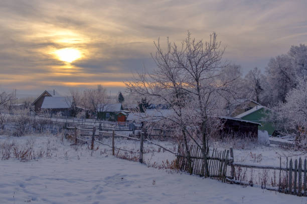 beautiful winter landscape with a view of a small village at sunset