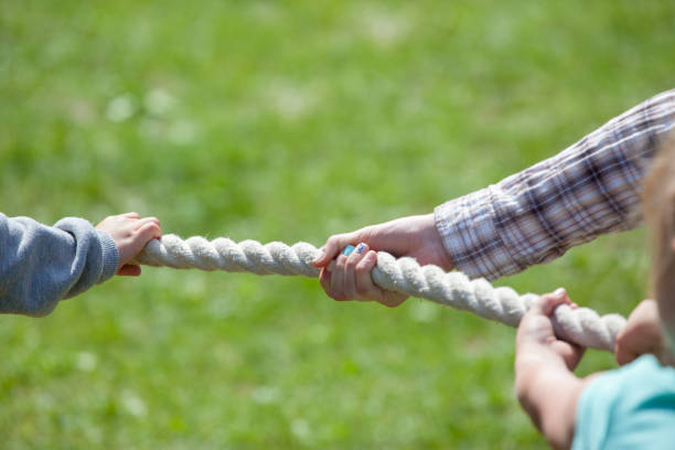 istock Children playing tug-of-war 1075526002