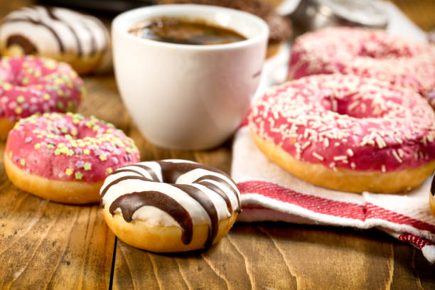 istock Sweet American donuts on table and cup of coffee 1075529174