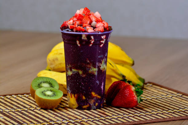 Glass with Acai, Strawberry, Kiwi, Banana and Mango Delicious refreshing dessert of acai berry and tropical fruits acai stock pictures, royalty-free photos & images