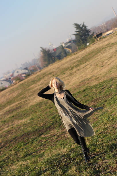 istock Attractive young blonde woman posing outside 1075532486