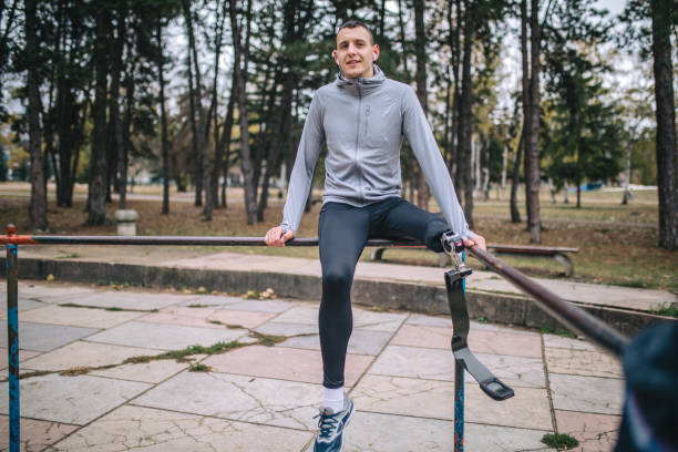 istock Smiling amputee athlete taking a break from running at a park 1075532722