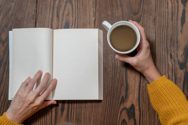 istock woman in yellow sweater is reading book while drinking coffee mock-up template 1075538304