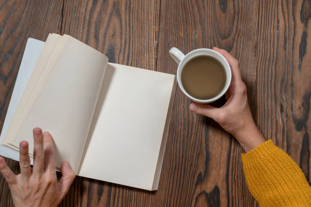 istock woman in yellow sweater is reading book while drinking coffee mock-up template 1075538306