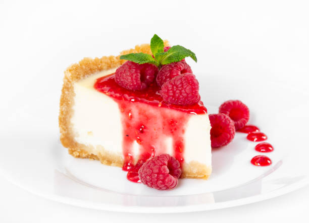 istock Piece of cheesecake with raspberries and mint on white background. 1075539960