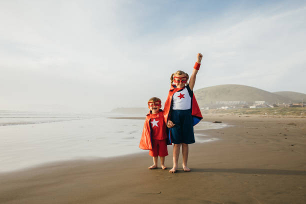 若い女の子とカリフォルニアのビーチの少年ヒーロー - partnership creativity superhero child ストックフォトと画像