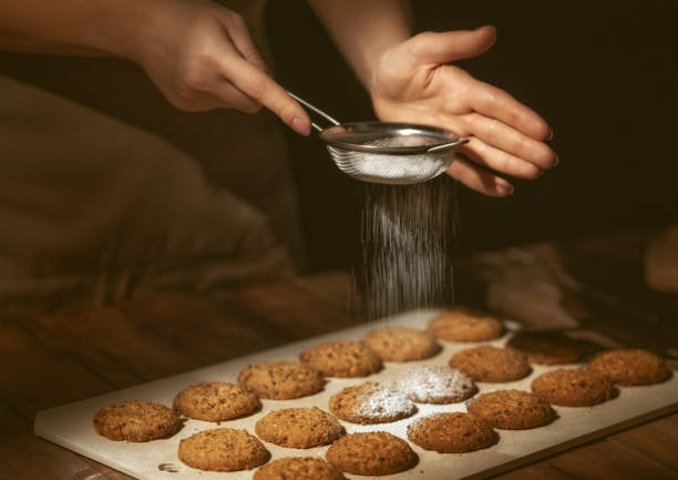 istock woman preparing biscuits on wooden table. 1075549294