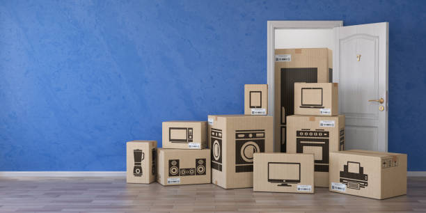 istock Household kitchen appliances and home electronics in cardboard boxes and open door. E-commerce, internet online shopping and delivery concept. 1075552928