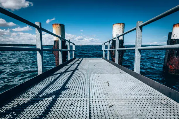 metal pier at the baltic sea in kiel, germany.