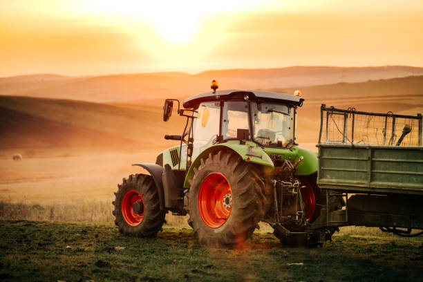 istock Farmer working in the fields with tractor on a sunset background. 1075556770