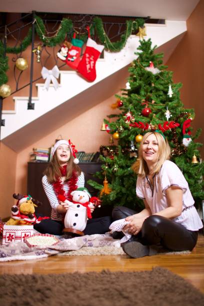 istock Christmas at home by tree with family 1075560138