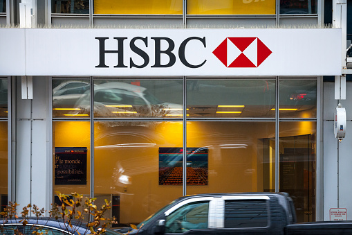 Picture of a sign with the logo of the HSBC Bank on its local branch in Montreal, Quebec. HSBC Bankis a british Financial institution, one of the largest banking and financial services organisations in the world.