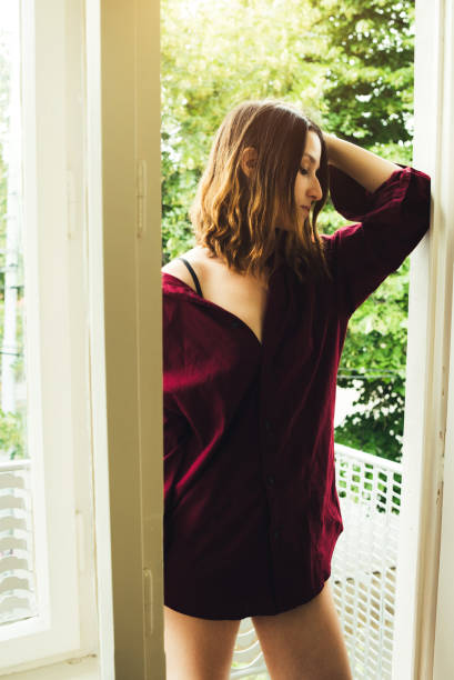 istock Girl clad in red by doorframe 1075574818