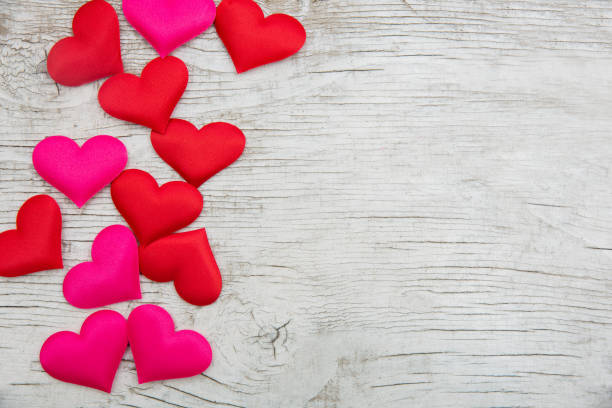 istock Hearts On White Wooden Table - Valentines Day Background 1075580908