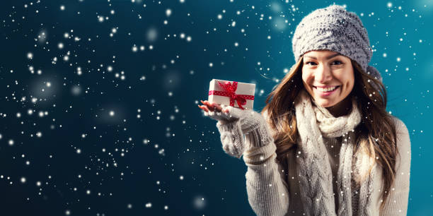 istock Young woman holding a Christmas gift 1075583648