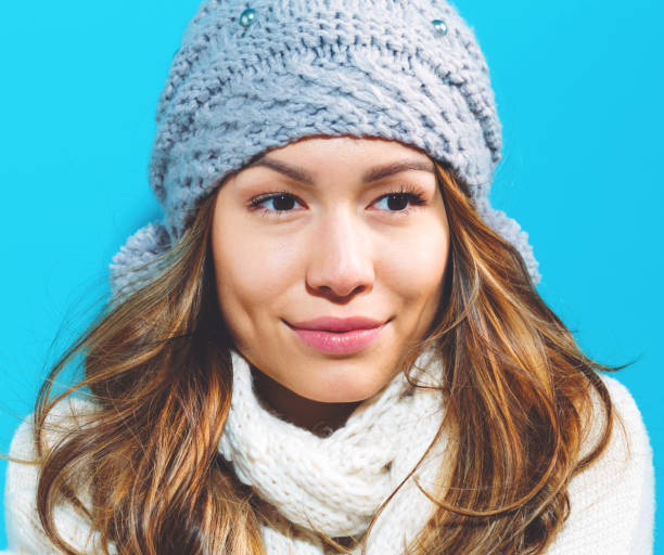 Young attractive African/American girl looking up from under a fur hood.