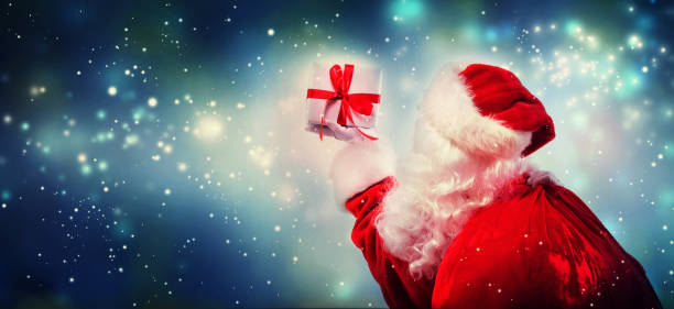 istock Santa holding a Christmas gift 1075583924