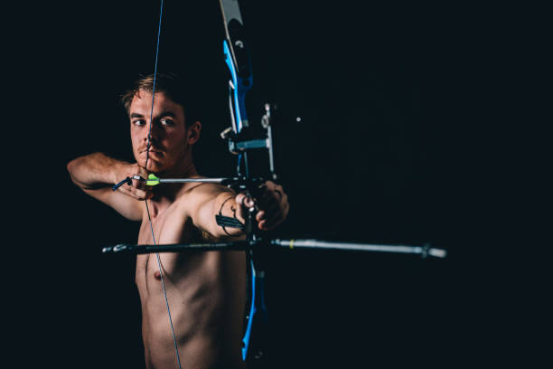 istock Young man with the bow and arrow 1075588612