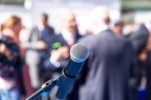 istock Microphone in focus against blurred people 1075589482