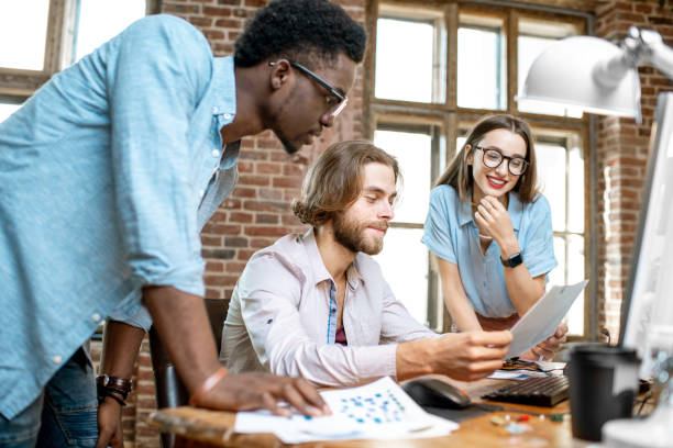 istock Young coworkers working with computer indoors 1075597346